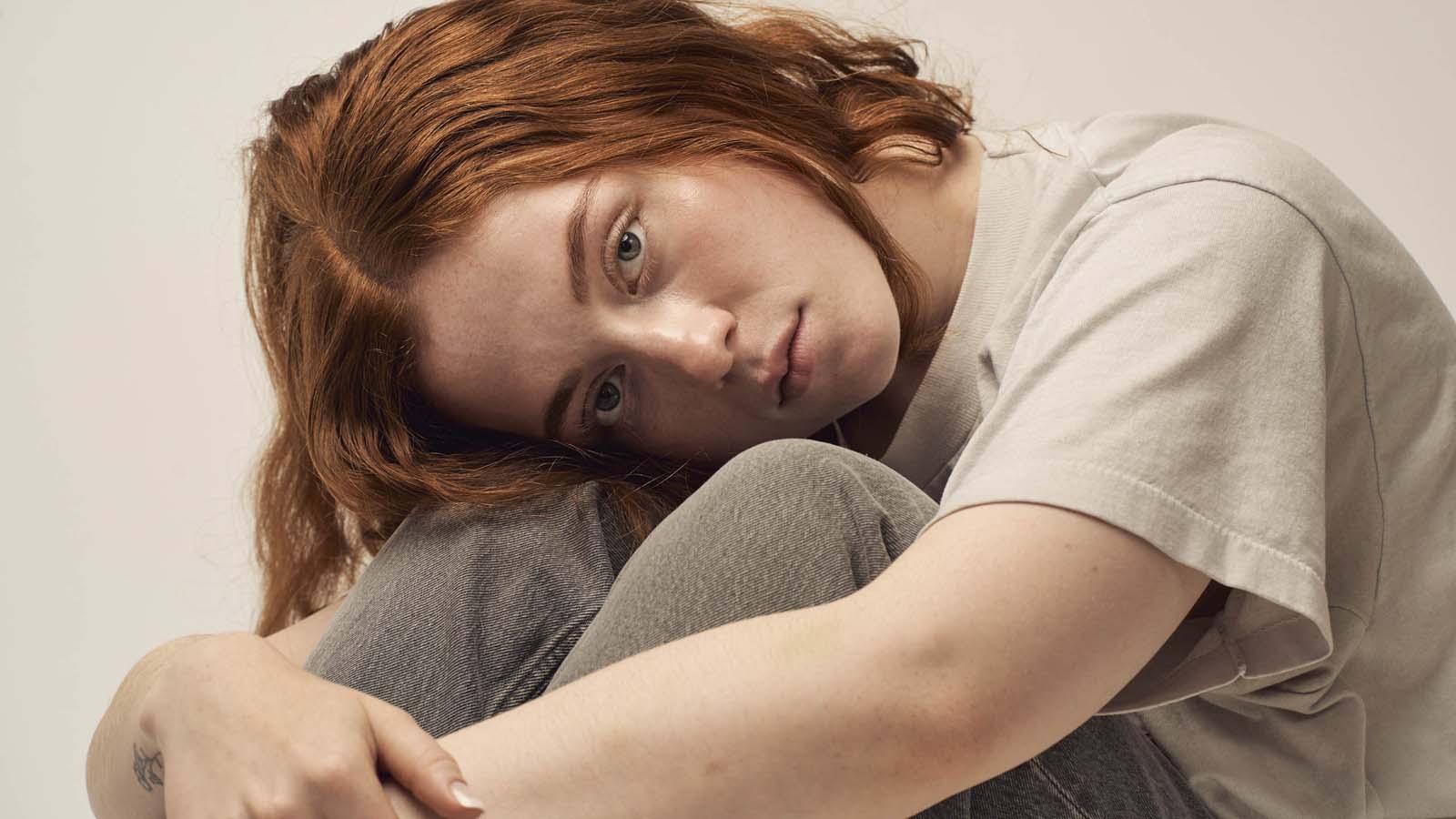 Redhead woman pensive authentic lifestyle portrait NYC