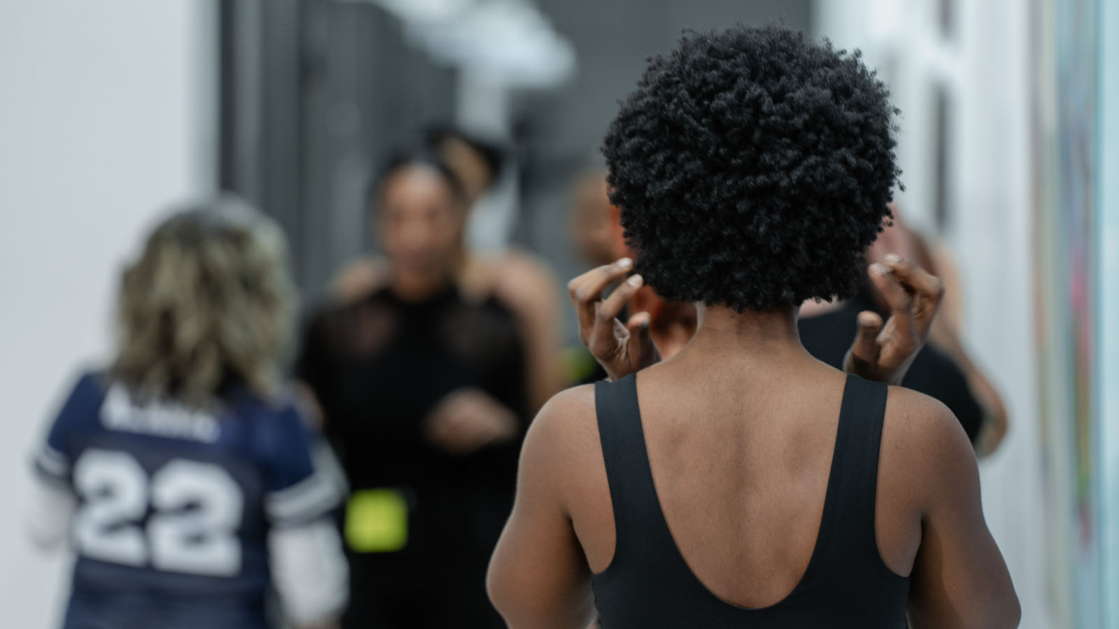 NYC art exhibition attendee viewing from behind candid event photography